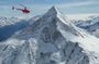 Private Swiss Alps helicopter tour over snow covered mountain peaks and glaciers